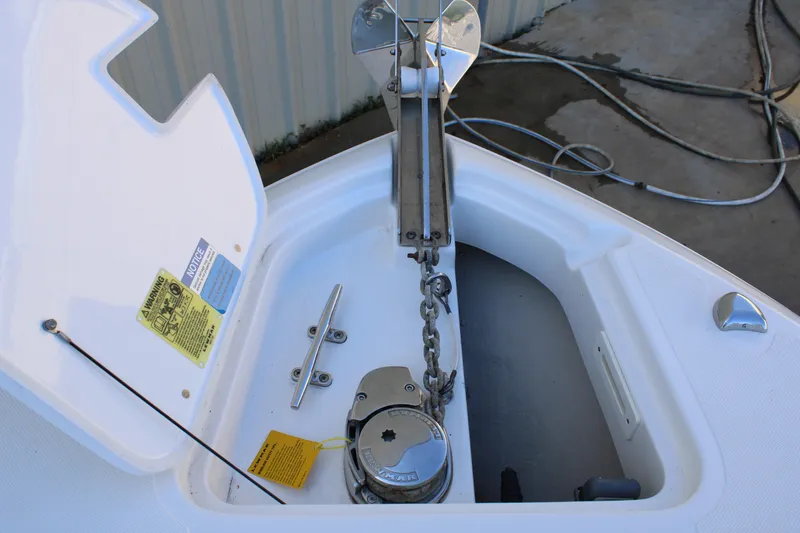 Slide: The Image of 2020 Pursuit DC 235 Dual Console boat interior with beige seating and speakers. - 43