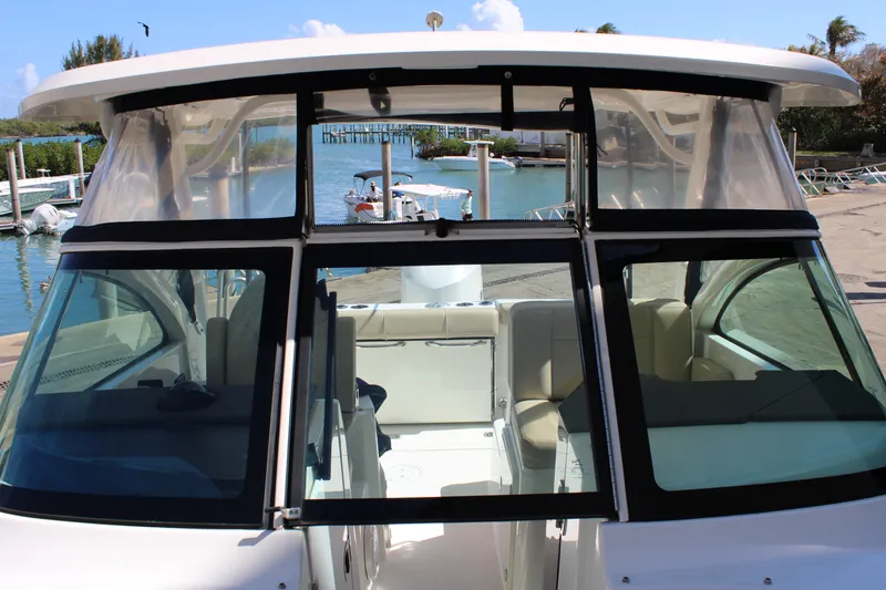 Slide: The Image of 2020 Pursuit DC 235 Dual Console boat docked by the water. - 46