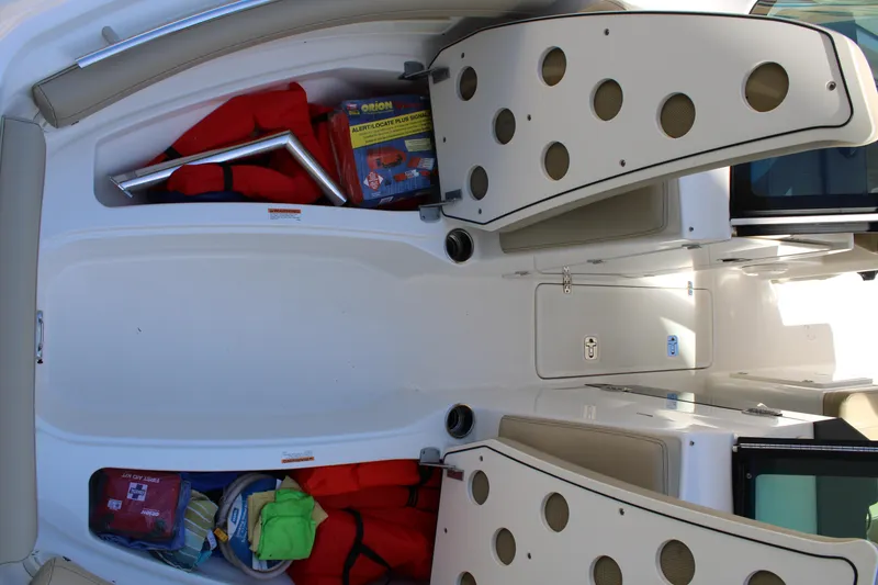 Slide: The Image of 2020 Pursuit DC 235 Dual Console boat docked by a scenic waterfront with palm trees. - 48