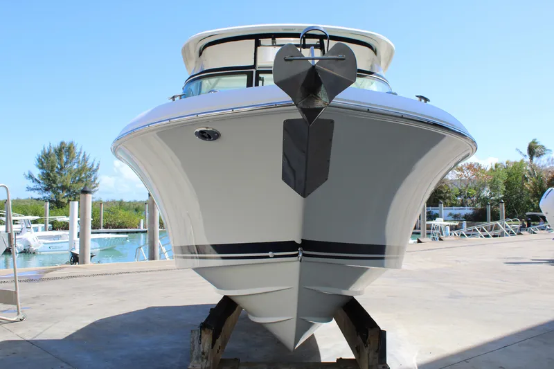 Slide: The Image of 2020 Pursuit DC 235 Dual Console boat on dock, front view, sunny day. - 7