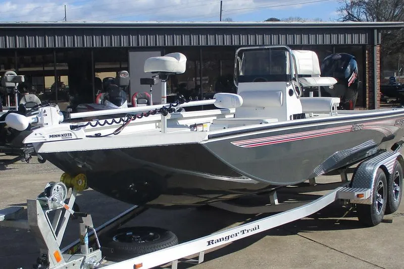 Slide: The Image of 2026 Ranger RB200 boat on trailer, parked outdoors, featuring Minn Kota trolling motor. - 11
