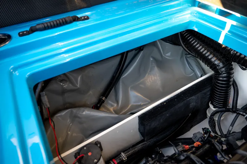 Slide: The Image of 2023 Yamaha Boats 222XD engine compartment with blue trim and wiring details. - 11