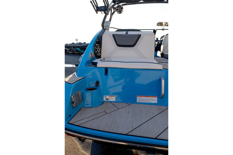 Slide: The Image of 2023 Yamaha Boats 222XD, blue deck with seating and speakers. - 16