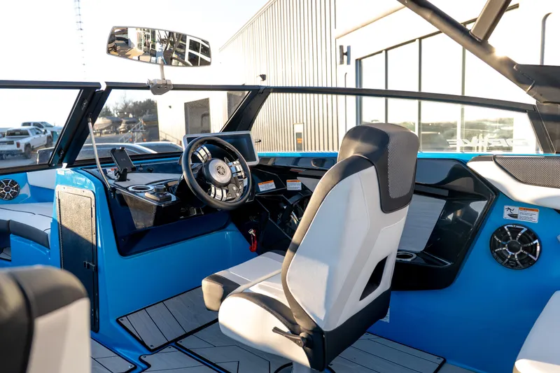 Slide: The Image of 2023 Yamaha Boats 222XD interior with modern steering and seating, showcasing sleek design. - 21