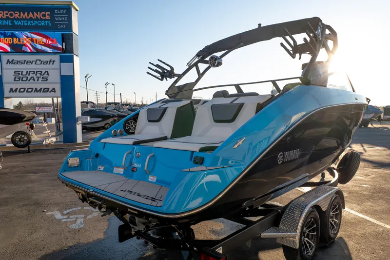 Slide: The Image of 2023 Yamaha Boats 222XD in blue, displayed at a marine dealership. - 3
