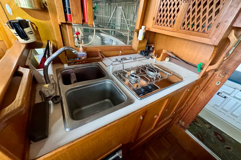 Slide: The Image of 1982 Tung Hwa Seahorse yacht kitchen with sink, stove, and wooden cabinetry. - 17