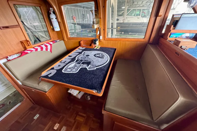 Slide: The Image of 1982 Tung Hwa Seahorse boat interior with seating and table, featuring nautical decor. - 18