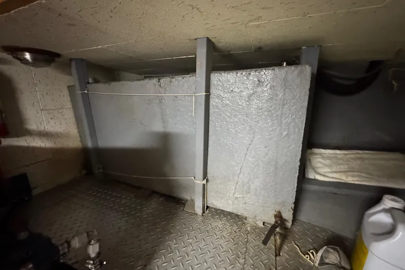 Slide: The Image of Engine room of 1982 Tung Hwa Seahorse boat with metal components and storage. - 29