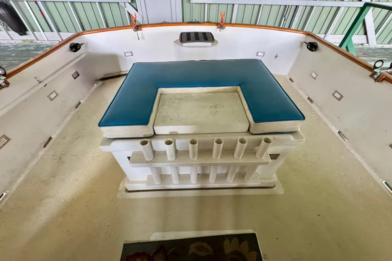 Slide: The Image of 1982 Tung Hwa Seahorse boat deck with blue cushioned seating and rod holders. - 30