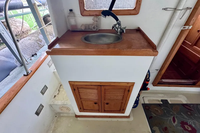 Slide: The Image of 1982 Tung Hwa Seahorse boat interior with wooden sink cabinet and faucet. - 32