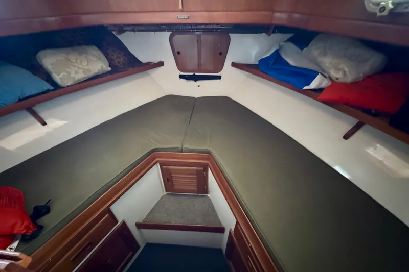 Slide: The Image of 1982 Tung Hwa Seahorse cabin interior with green cushions and colorful pillows. - 5