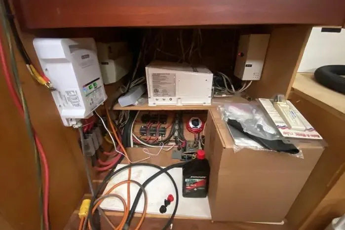Slide: The Image of Electrical system inside a 1966 Vanguard Bermudian Sloop, featuring wiring and equipment. - 12