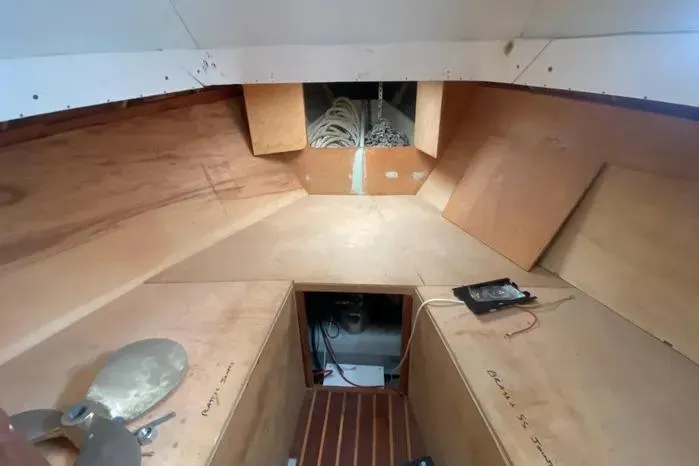 Slide: The Image of 1966 Vanguard Bermudian Sloop interior with wooden panels and storage space. - 17