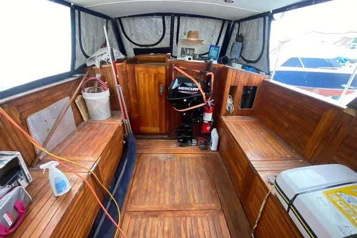Slide: The Image of 1966 Vanguard Bermudian Sloop interior with wooden seating and Mercury engine. - 21