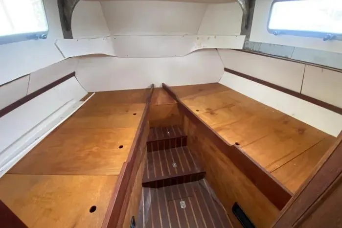 Slide: The Image of Interior of a 1966 Vanguard Bermudian Sloop, featuring wooden benches and steps. - 22