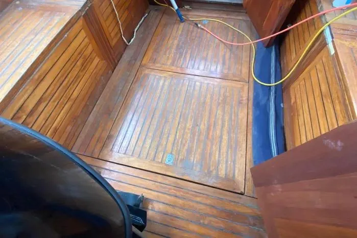 Slide: The Image of 1966 Vanguard Bermudian Sloop interior with wooden flooring and storage compartments. - 24