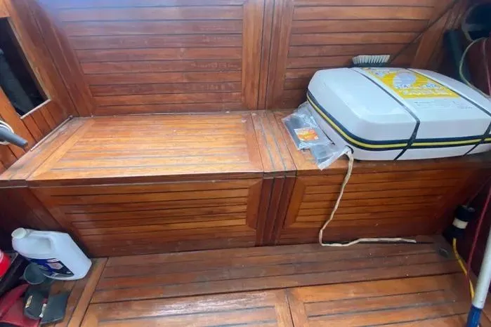 Slide: The Image of Interior of 1966 Vanguard Bermudian Sloop with wooden paneling and storage area. - 25