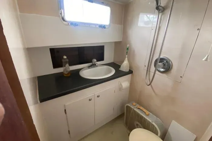Slide: The Image of Bathroom interior of 1966 Vanguard Bermudian Sloop with sink, shower, and window. - 26