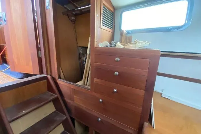 Slide: The Image of Interior of 1966 Vanguard Bermudian Sloop with wooden cabinetry and stairs. - 27