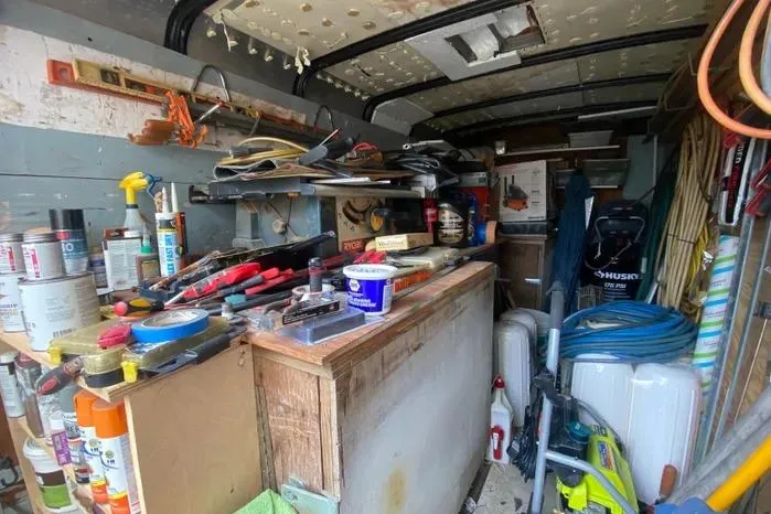 Slide: The Image of Cluttered workshop inside a 1966 Vanguard Bermudian Sloop, filled with tools and supplies. - 29