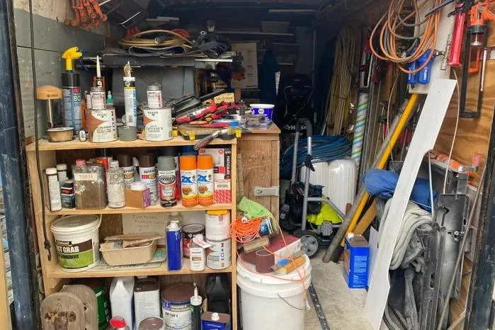 Slide: The Image of Cluttered workshop with tools, paint cans, and supplies; Vanguard Bermudian Sloop, 1966. - 30