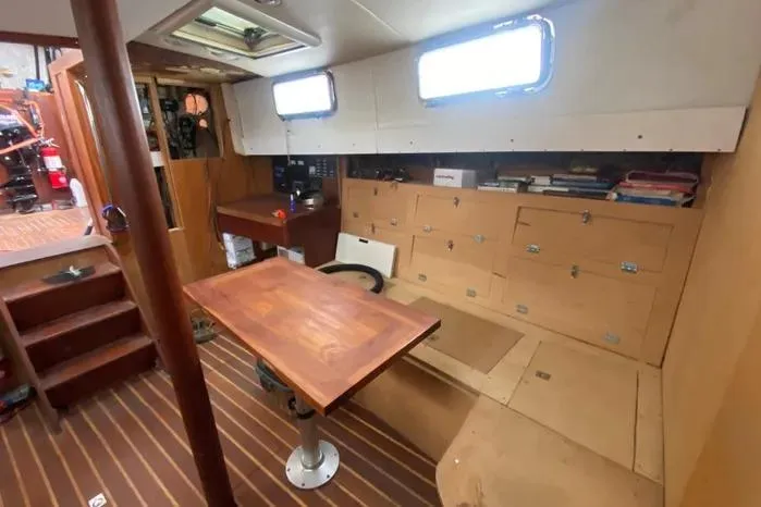 Slide: The Image of Interior of 1966 Vanguard Bermudian Sloop with wooden table and storage cabinets. - 6