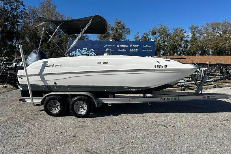The Image of 2019 Hurricane SunDeck Sport 188 OB boat on trailer, parked outdoors. - 0