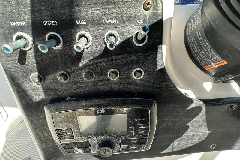 Slide: The Image of Control panel of 2019 Hurricane SunDeck Sport 188 OB boat with switches and stereo. - 17