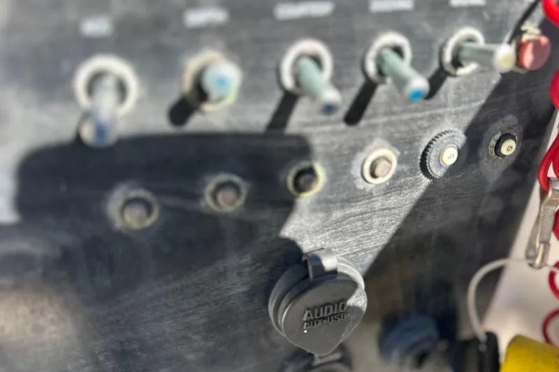 Slide: The Image of Control panel of a 2019 Hurricane SunDeck Sport 188 OB boat with switches and audio input. - 18