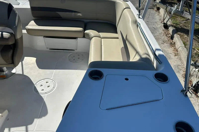 Slide: The Image of 2019 Hurricane SunDeck Sport 188 OB interior with beige seating and cup holders. - 22
