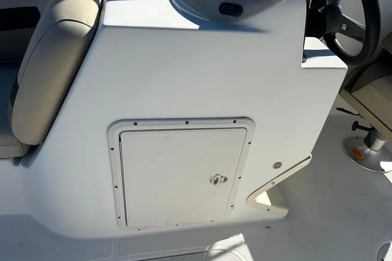 Slide: The Image of 2019 Hurricane SunDeck Sport 188 OB boat console with storage compartment. - 23