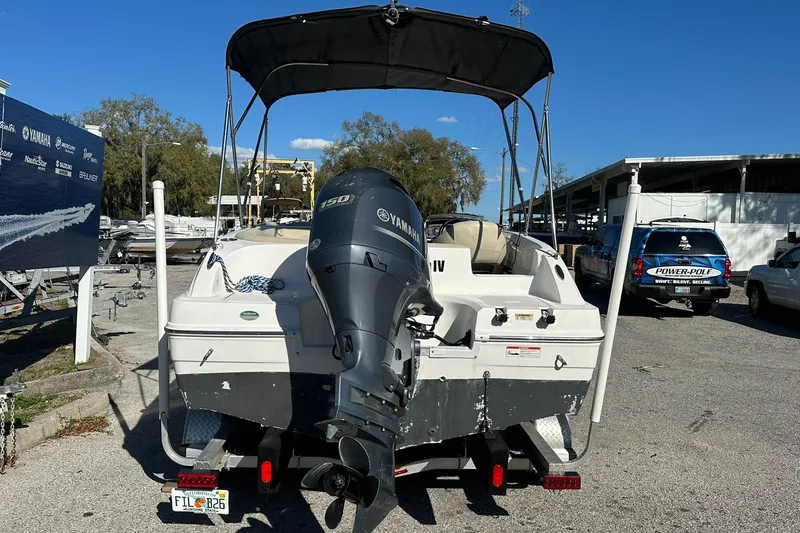 Slide: The Image of 2019 Hurricane SunDeck Sport 188 OB boat with Yamaha outboard motor, parked on a trailer. - 25