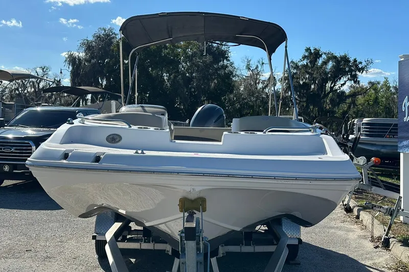 Slide: The Image of 2019 Hurricane SunDeck Sport 188 OB boat on trailer, parked outdoors under clear sky. - 5