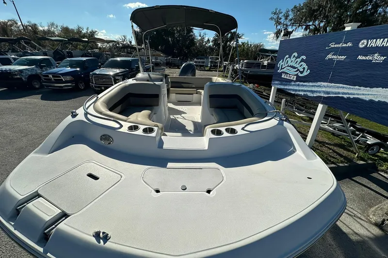 Slide: The Image of 2019 Hurricane SunDeck Sport 188 OB boat with seating, parked at a marina. - 6