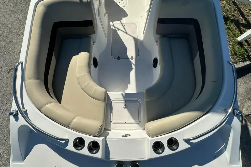 Slide: The Image of 2019 Hurricane SunDeck Sport 188 OB boat interior with beige seating and cup holders. - 8