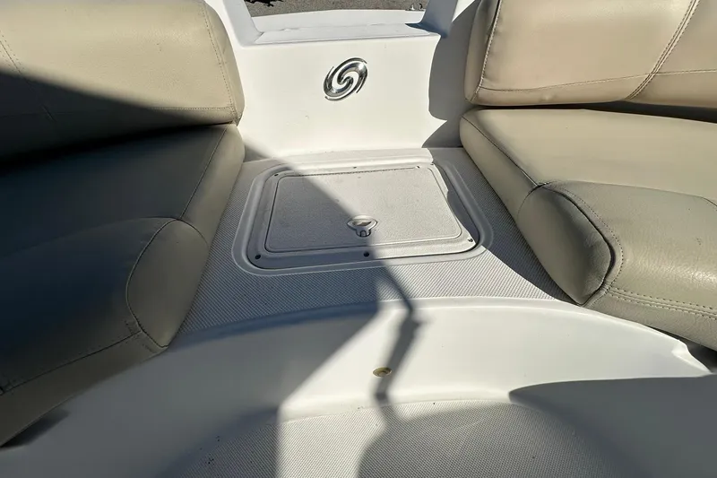 Slide: The Image of 2019 Hurricane SunDeck Sport 188 OB boat seating area with storage compartment. - 9