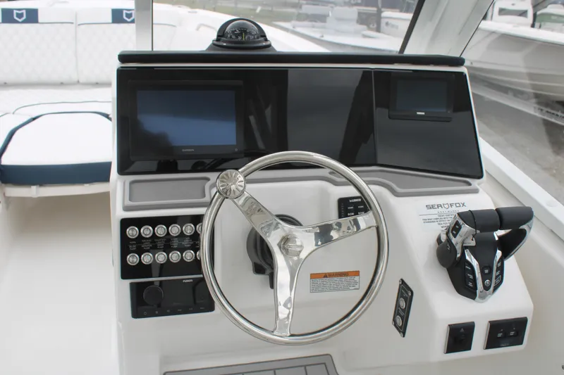 Slide: The Image of 2026 Sea Fox 268 Traveler boat dashboard with steering wheel and controls. - 10