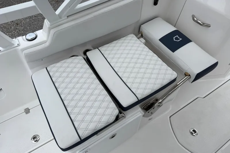 Slide: The Image of 2026 Sea Fox 268 Traveler boat seating with white and navy cushioned design. - 13