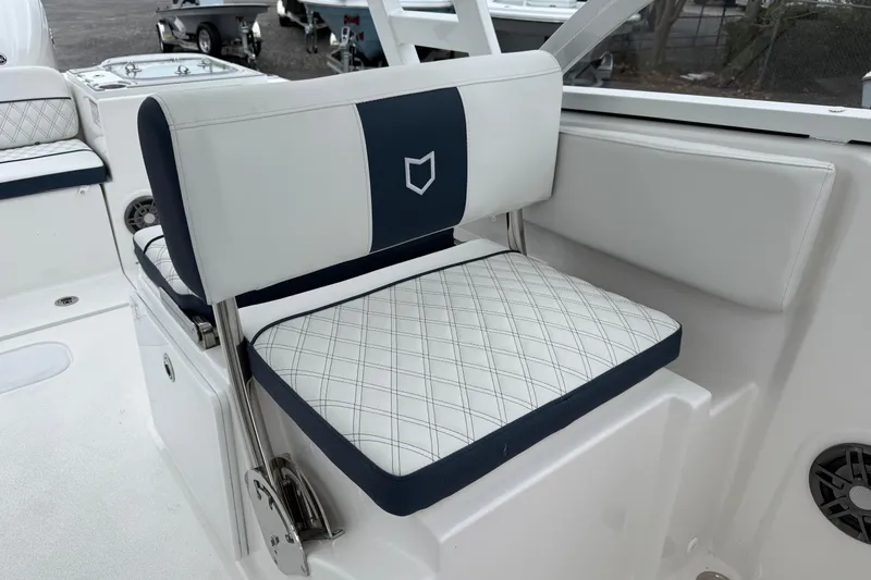 Slide: The Image of 2026 Sea Fox 268 Traveler boat seat with white and navy upholstery. - 23