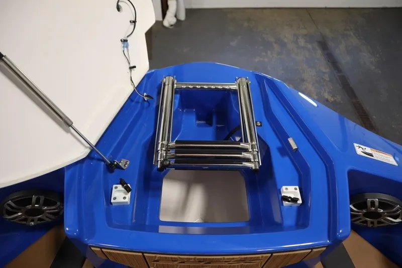 Slide: The Image of 2024 Yamaha Boats 222XE blue deck with stainless steel ladder and speakers. - 14