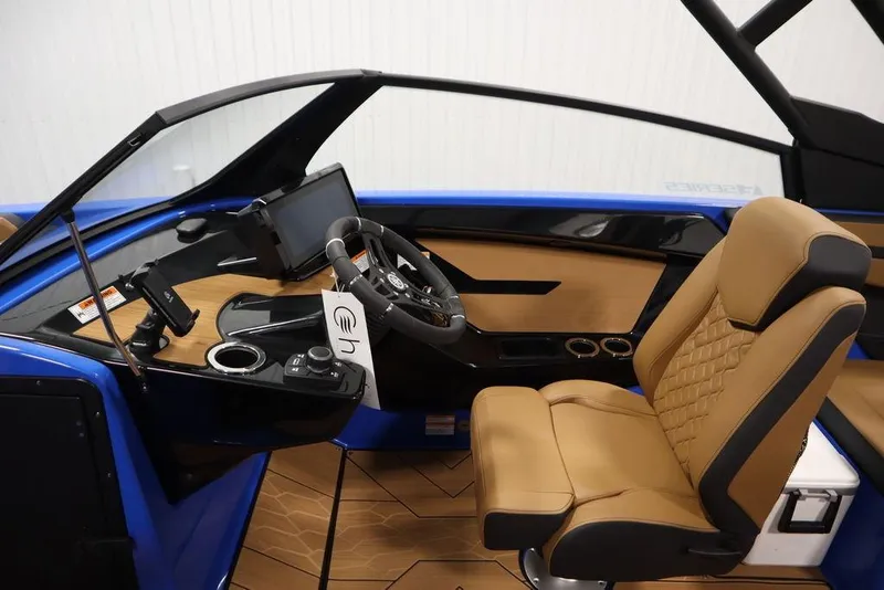 Slide: The Image of 2024 Yamaha Boats 222XE cockpit with modern dashboard and luxurious tan seating. - 21
