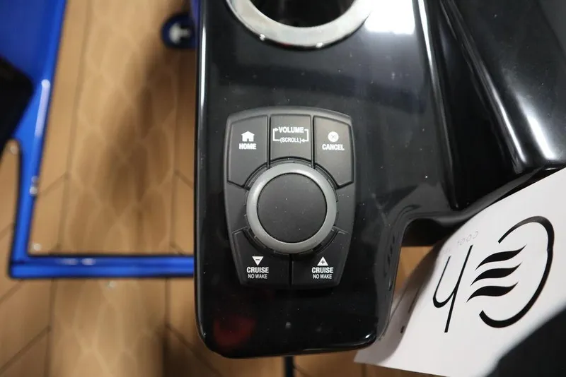Slide: The Image of Control panel of 2024 Yamaha Boats 222XE with navigation and volume buttons. - 23