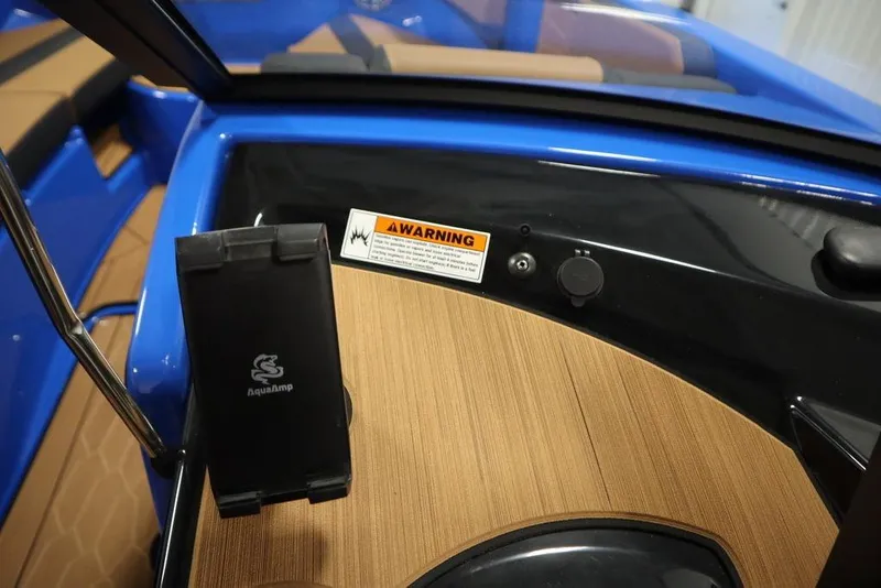Slide: The Image of 2024 Yamaha Boats 222XE dashboard with warning label and AquaAmp holder. - 24