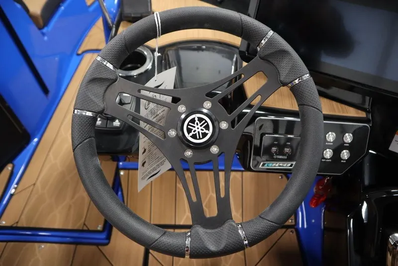 Slide: The Image of 2024 Yamaha Boats 222XE steering wheel and dashboard, featuring sleek design and controls. - 25