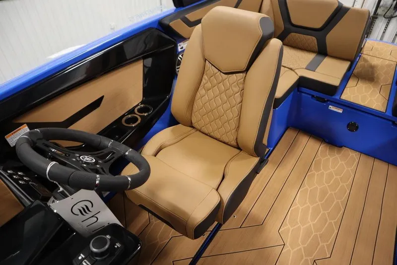 Slide: The Image of 2024 Yamaha Boats 222XE interior with tan seating and modern steering wheel design. - 27