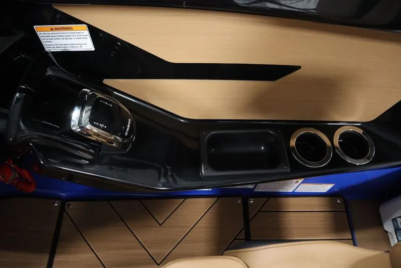 Slide: The Image of 2024 Yamaha Boats 222XE interior with control panel, cup holders, and wood accents. - 29