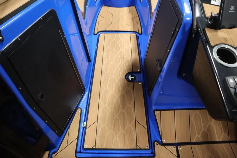 Slide: The Image of 2024 Yamaha Boats 222XE interior with blue accents and wood-patterned flooring. - 32