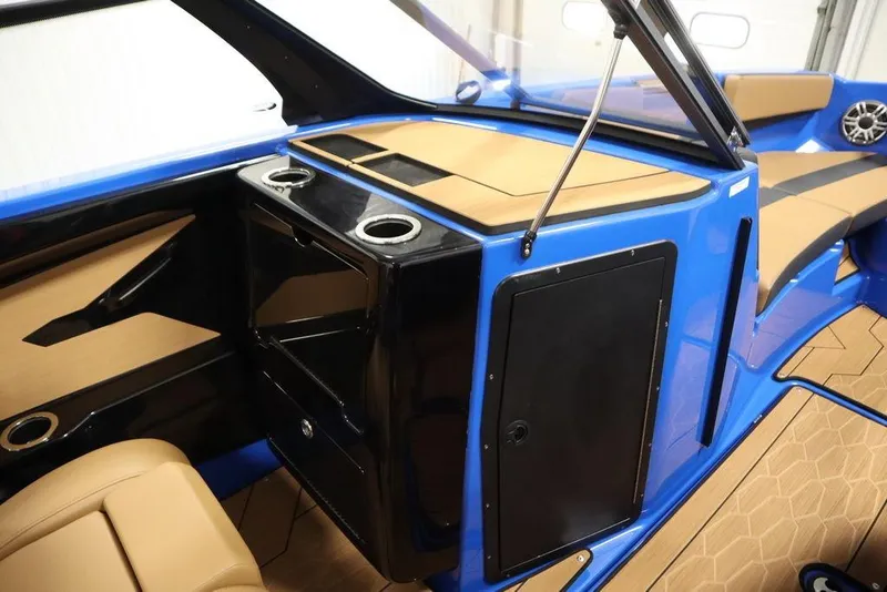 Slide: The Image of 2024 Yamaha Boats 222XE interior with blue and tan design, featuring cup holders and seating. - 33