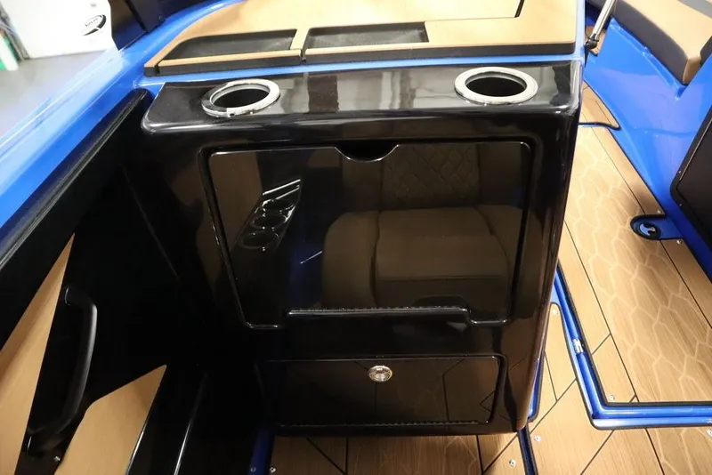 Slide: The Image of 2024 Yamaha Boats 222XE interior with cup holders and sleek black cabinetry. - 35