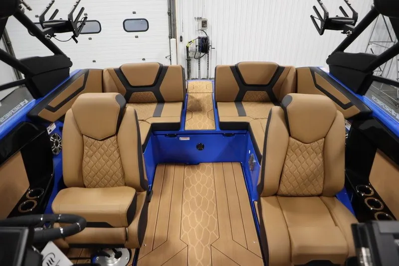 Slide: The Image of 2024 Yamaha Boats 222XE interior with tan quilted seats and blue accents. - 39